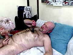 A mature woman passionately gives oral pleasure to her bald partner and receives his ejaculation on her face