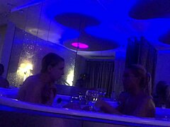 Two blonde bombshells engage in a steamy bathtub lesbian scene